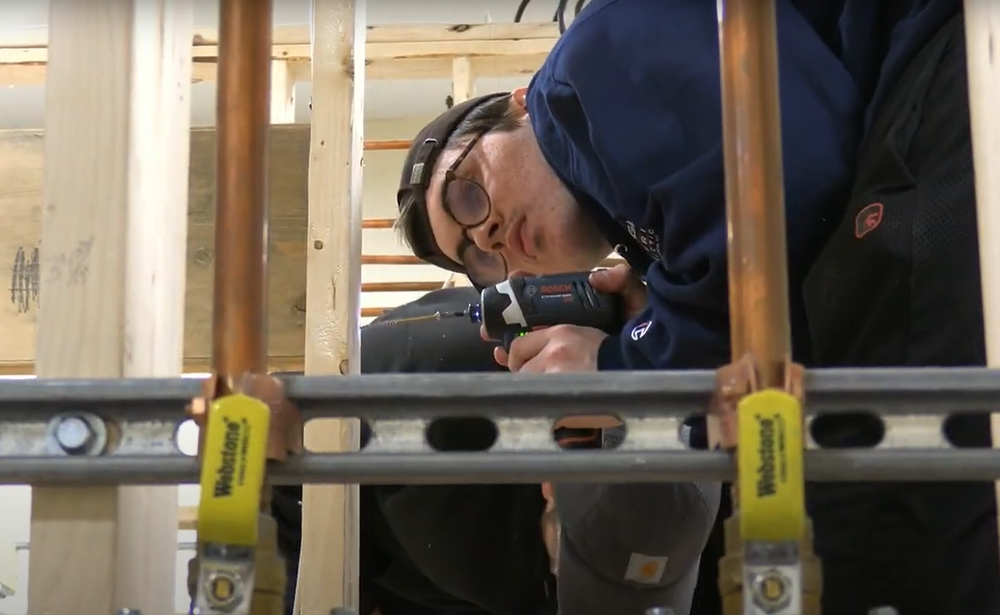 Student working with a drill